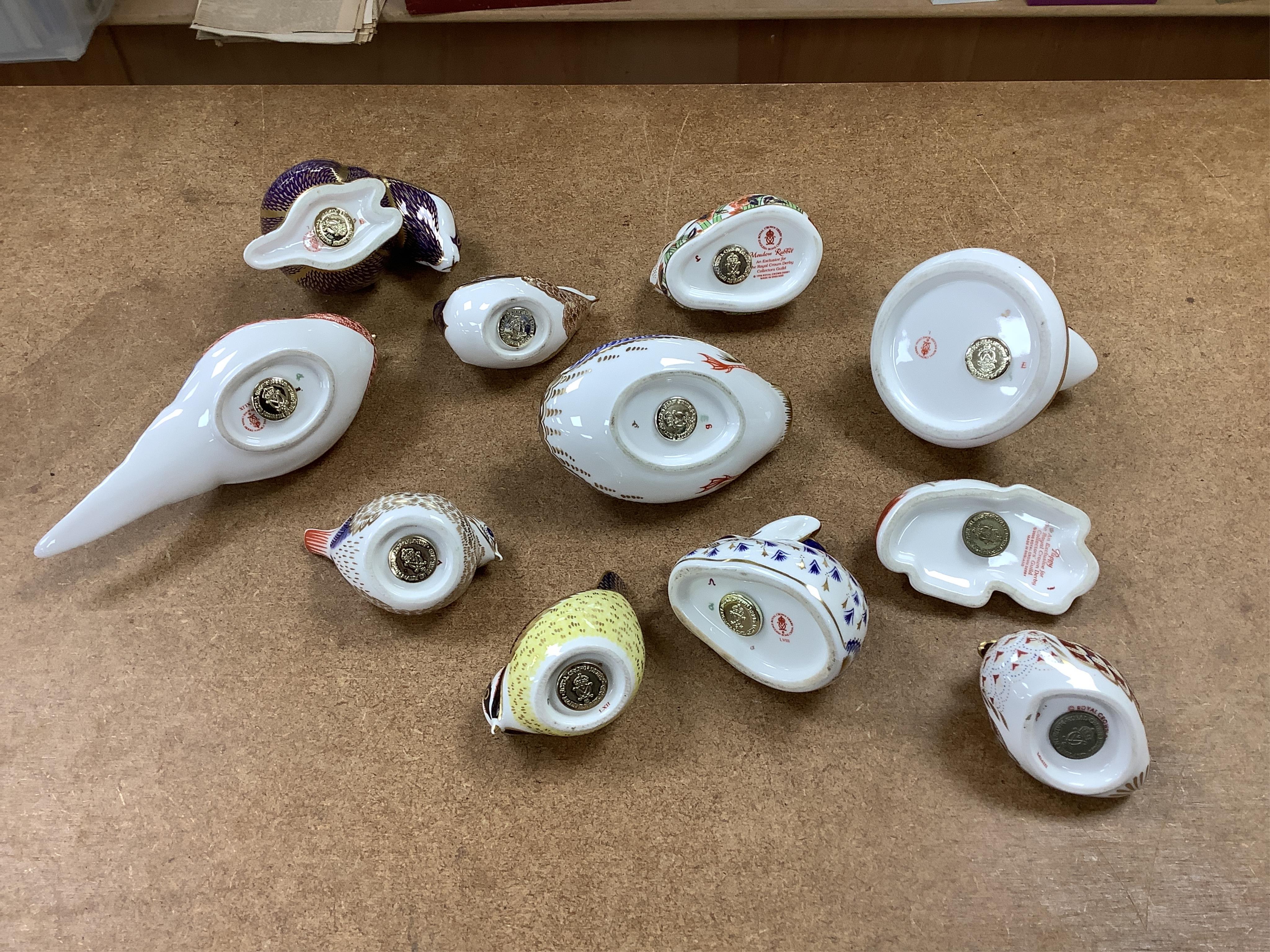 A collection of Royal Crown Derby Imari pattern paperweights, to include penguin and badger, together with three Doulton flambé animals, largest 19cm wide